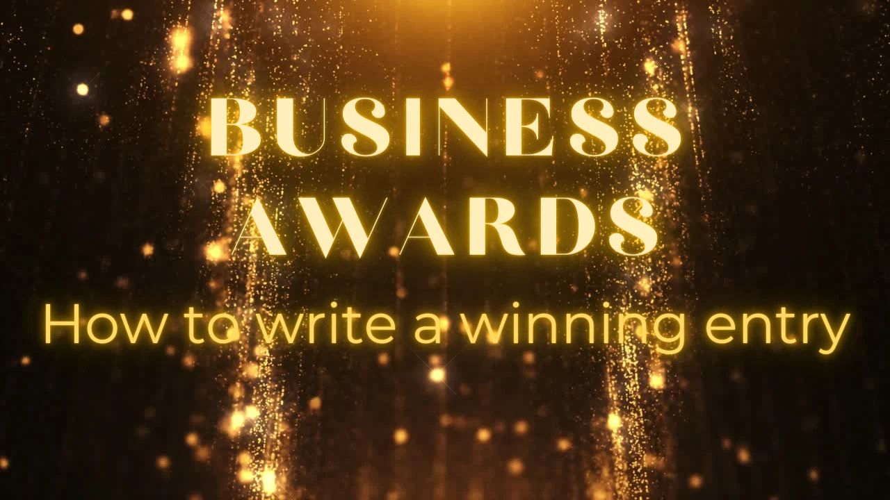 Words in gold text on a black background. The words are Business Awards - How to write a winning entry.