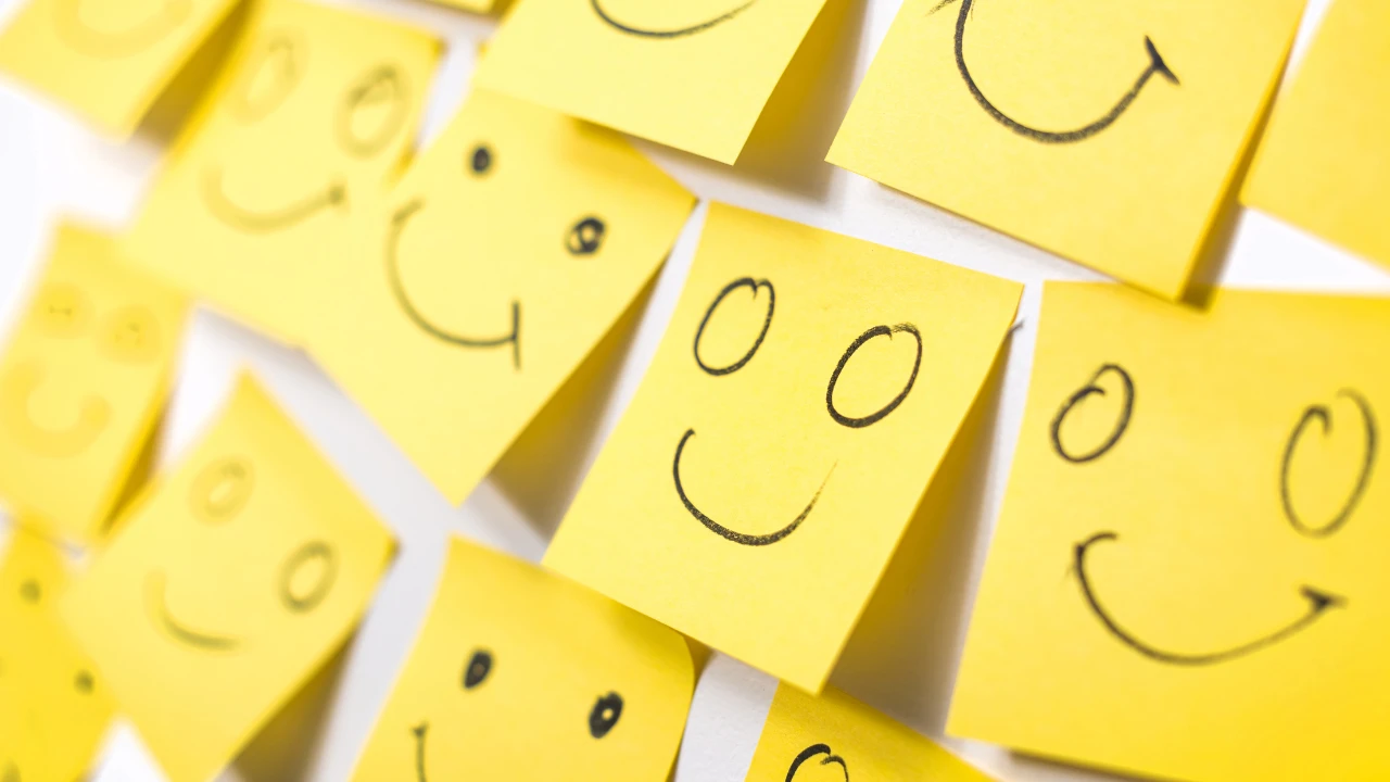 A series of yellow post it notes with smiley faces.