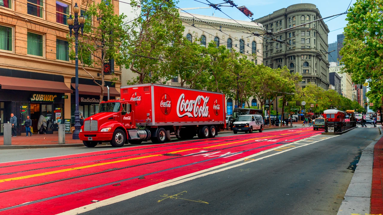 The Coca Cola truck parked in a city centre.