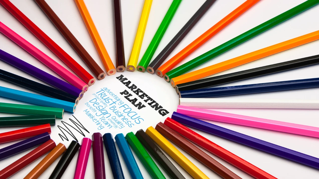 Coloured pencils arranged in a circle with the words marketing plan in the centre.