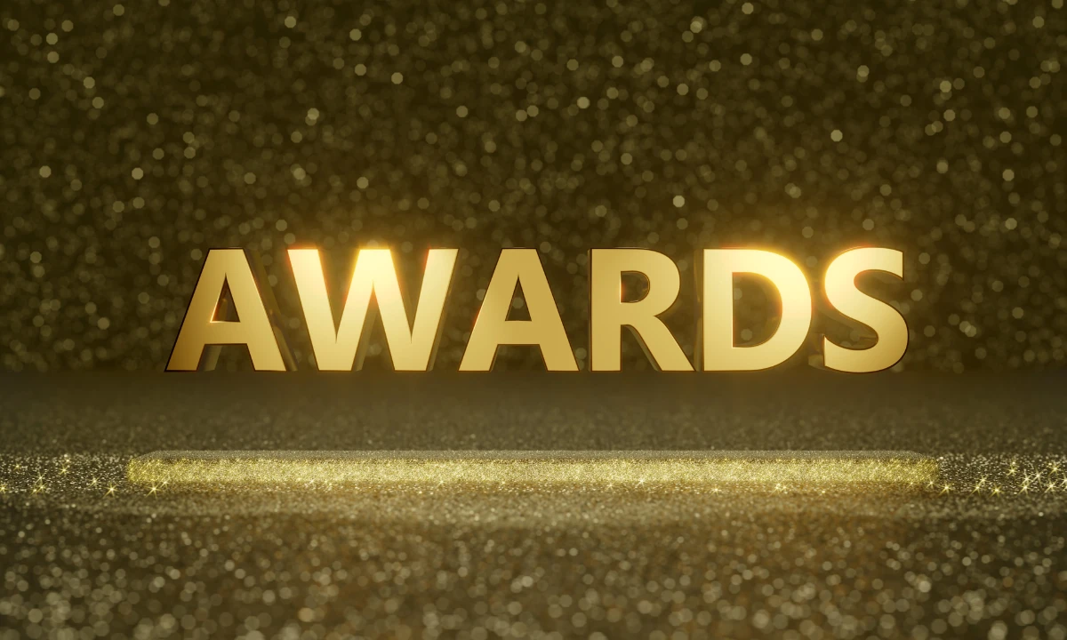 The word AWARDS in gold text on a black and gold background.