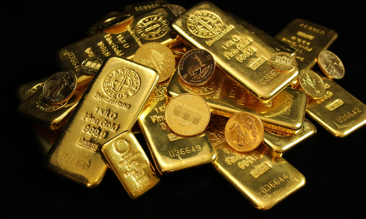 Gold nuggets and coins on a black background. The Troubleshooter logo in the foreground.