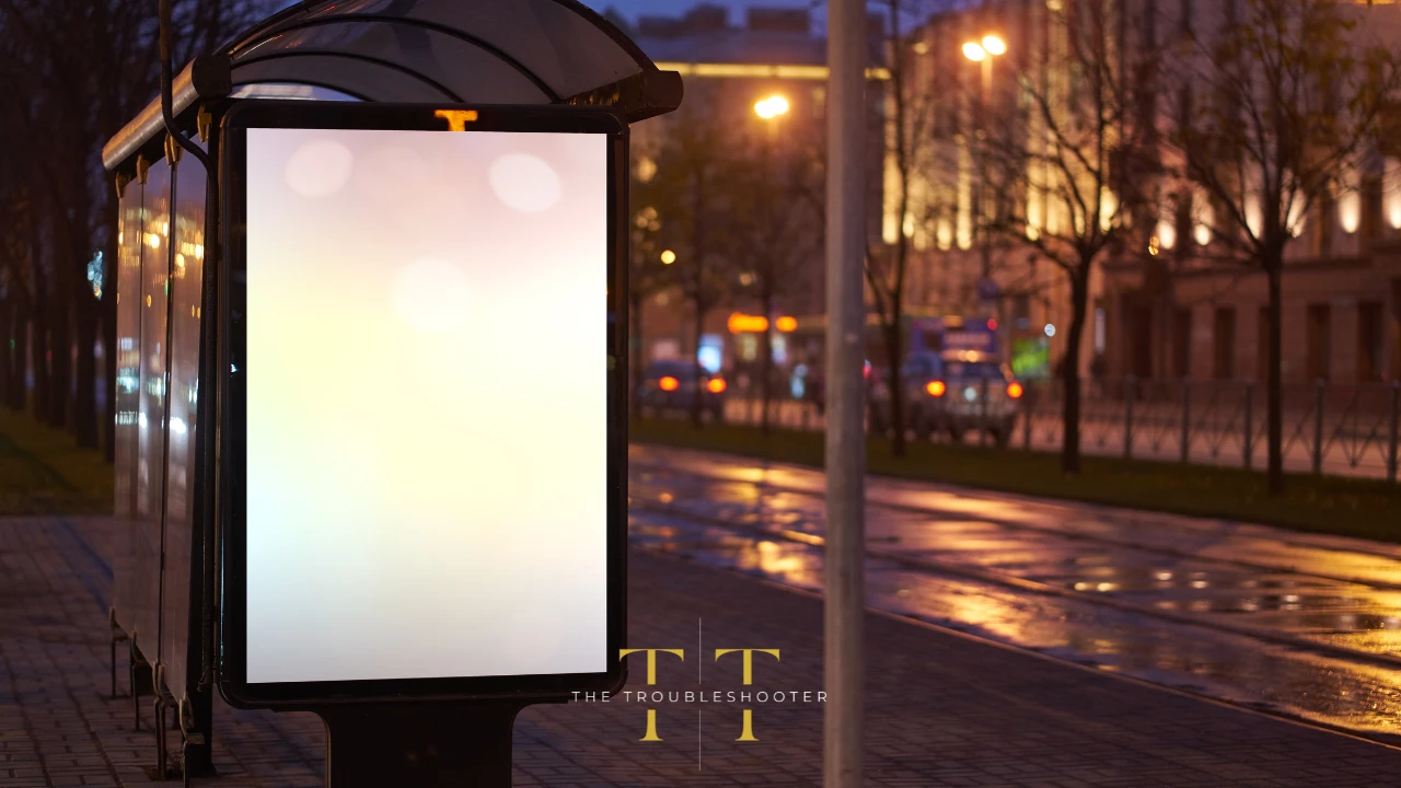 The side shot of a bus shelter with an empty panel at night. The Troubleshooter logo in the foreground.