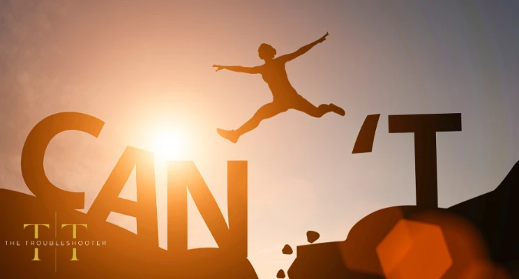 A silhouetted image of a person jumping over the word can't. The Troubleshooter logo in the foreground.