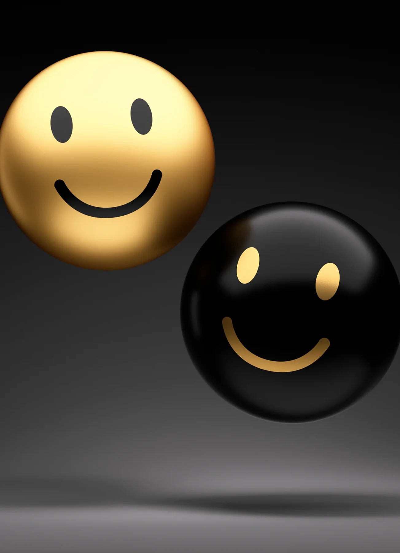 Two gold and black smiley-faced spheres hovering above a grey canvas